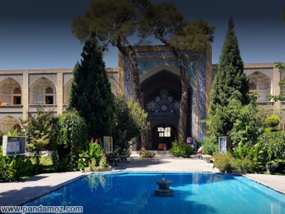 عکس حوزه علمیه صدر اصفهان. تصویر حیاط و درختان و حوض پر از آب در حیاط و نمای ساختمان