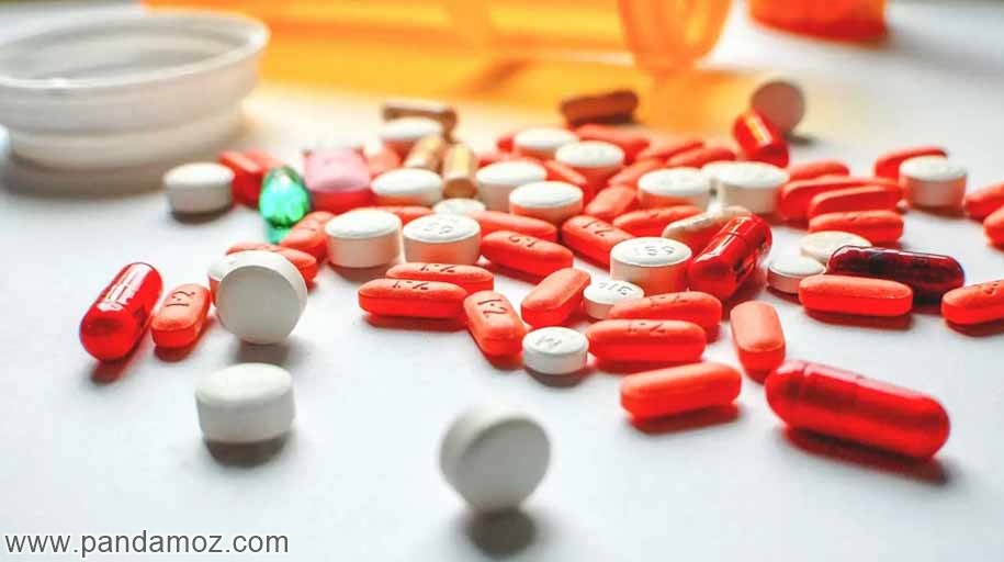 عکس تصویر تعدادی دارو و قرص به رنگهای نارنجی قرمز و سفید